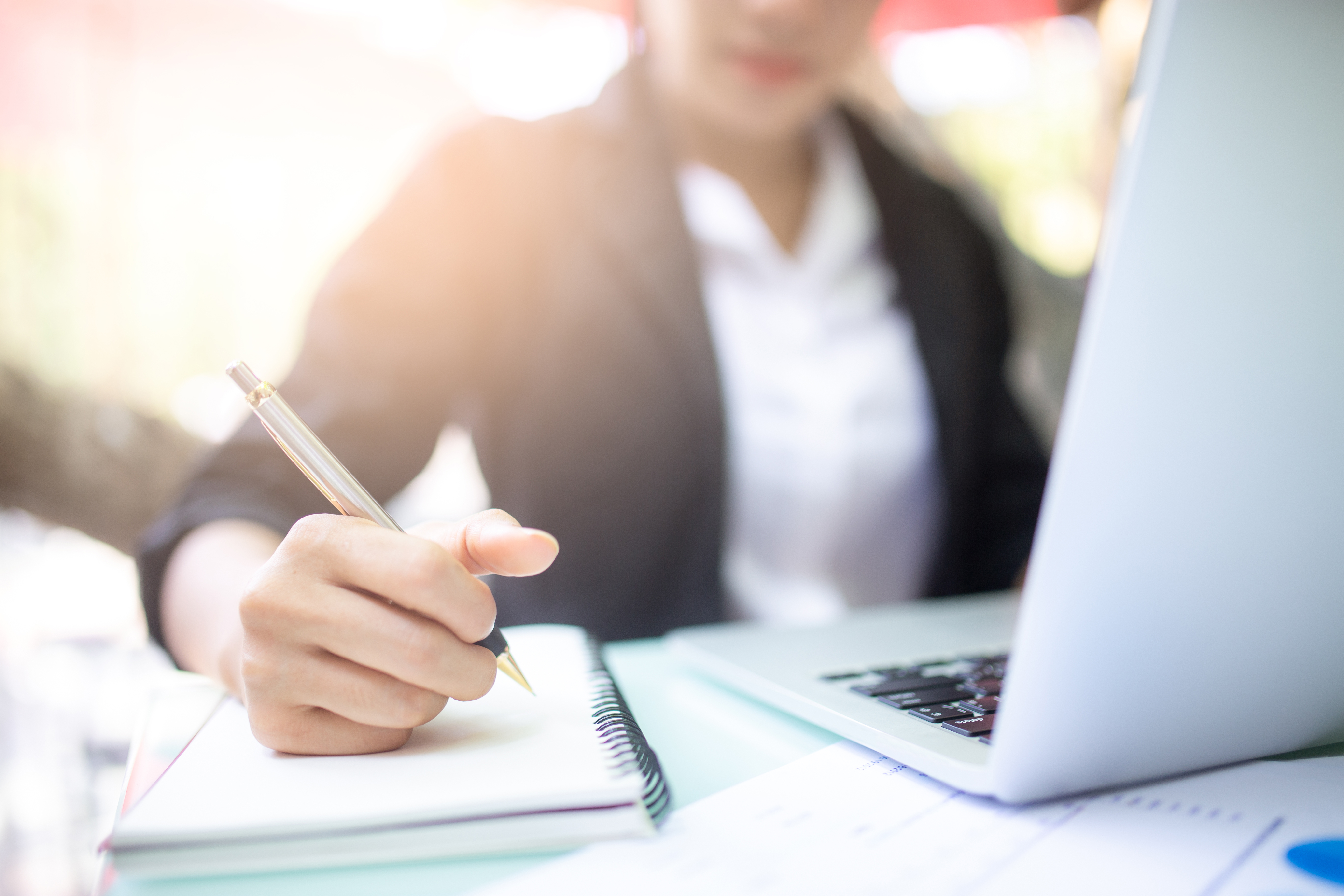 elearning woman at computer with notebook iStock-1124339065